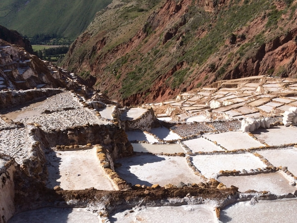 Looking over salt ponds at Salineras de Maras with the Sacred Valley in the background