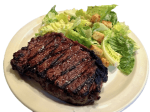 Grains of Sacred Valley Salt sprinkled on a grilled steak