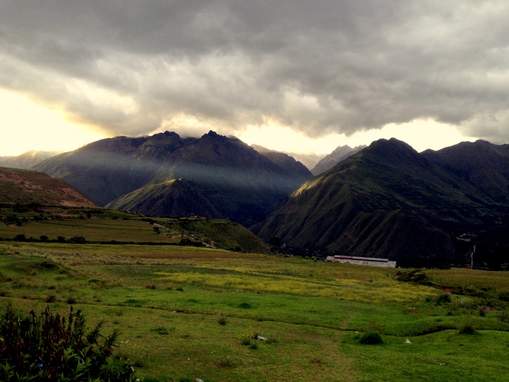 sun breaking through clouds on rim of sacred valley near Urubamba