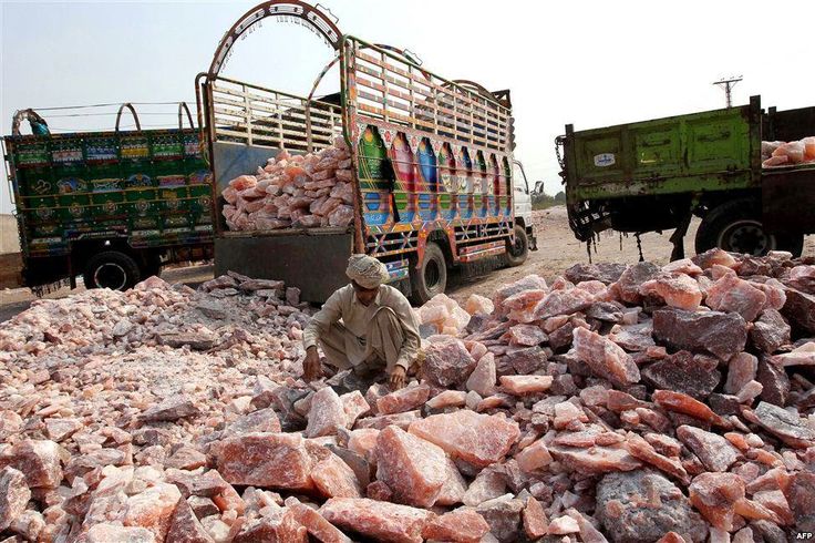 Workers loading blocks of Himalayan pink salt onto trucks